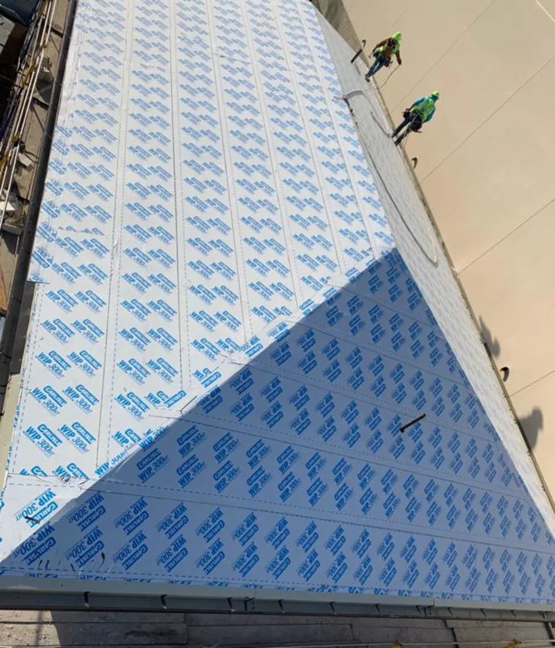 Professional roofers installing underlayment on a metal roof in Spotsylvania Courthouse